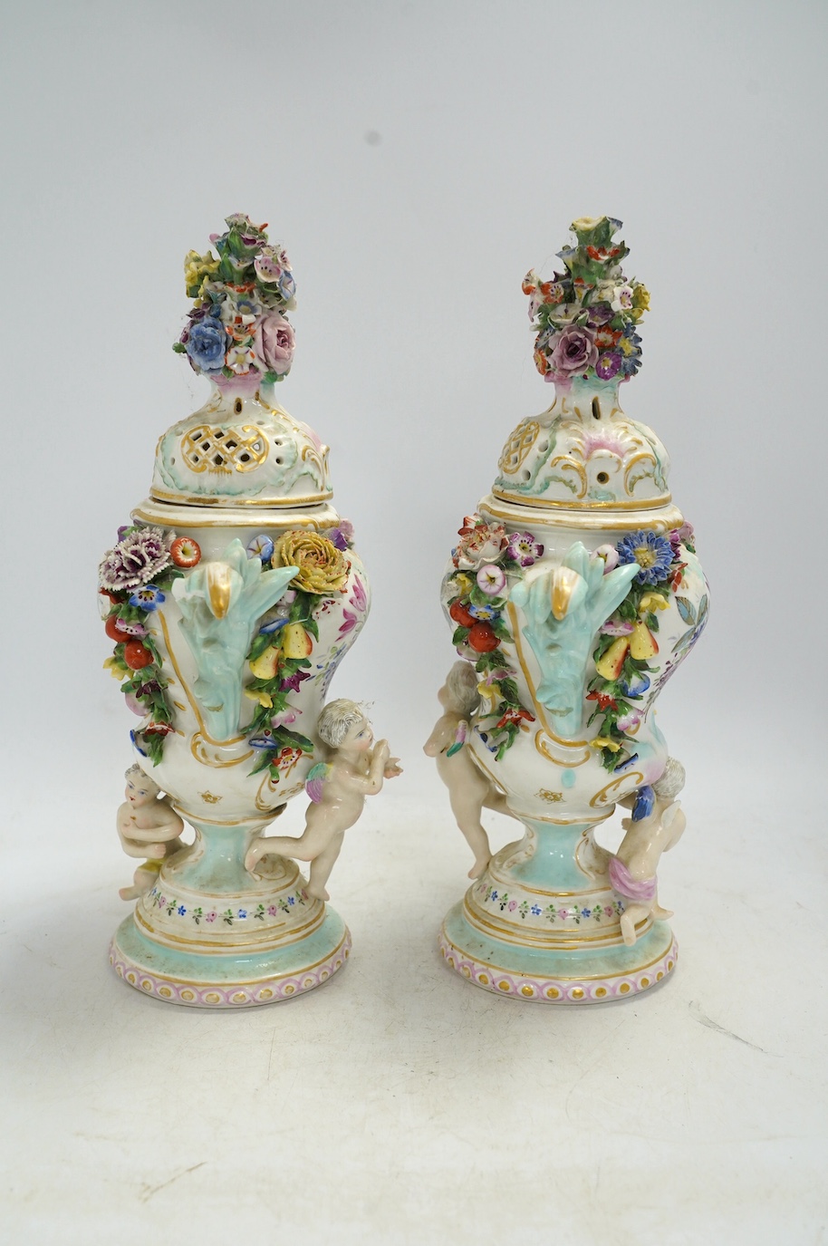 A pair of Potschappel porcelain floral encrusted vases and covers, 31cm high. Condition - poor